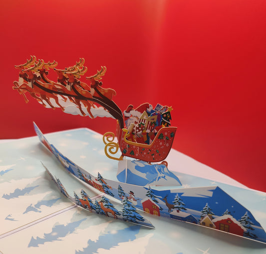 Santa and his reindeers flying high pop up greeting card