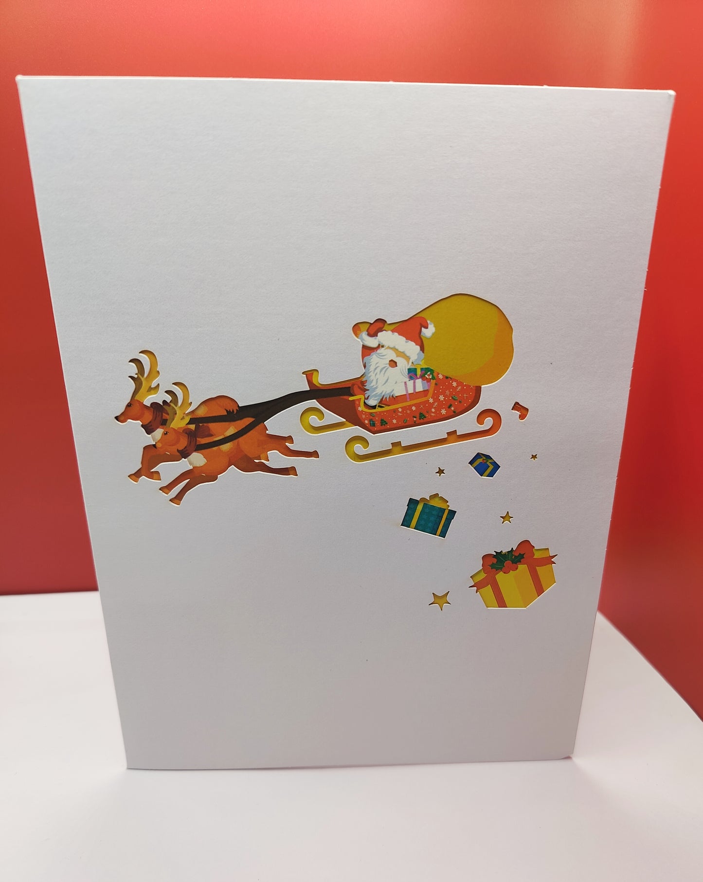 Santa and his reindeers flying high pop up greeting card